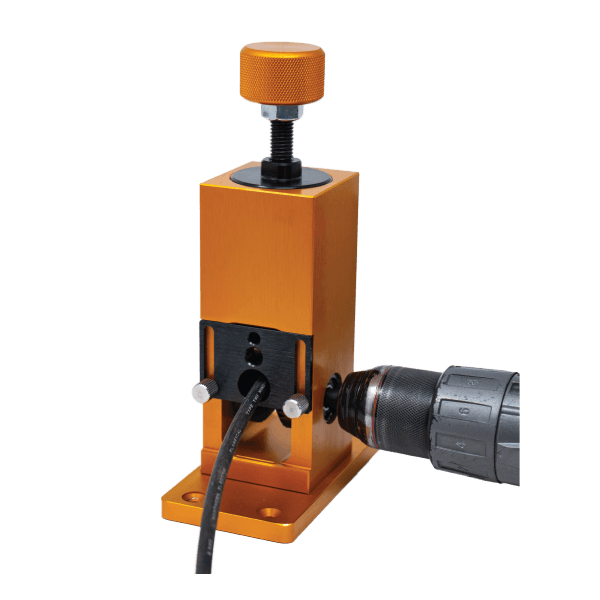 Rack-A-Tier Wire Peeler wire stripping machine in bronze colour. A drill is attached to the side and a wire is fed into the front.